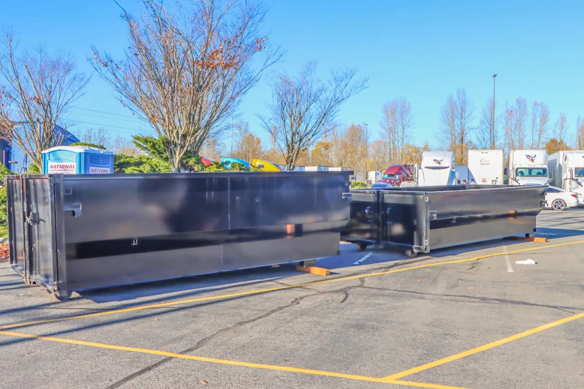 Professional dumpster rental service with roll-off container on residential driveway in Youngsville